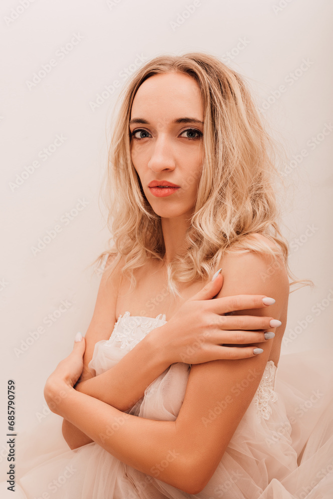 Beautiful woman in white dress sitting at table. Reverie, anticipation Beautiful woman in white dress sitting at table. Reverie, anticipation