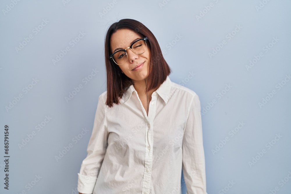 Young hispanic woman standing over white background winking looking at the camera with sexy expression, cheerful and happy face. Young hispanic woman standing over white background winking looking at the camera with sexy expression, cheerful and happy face.