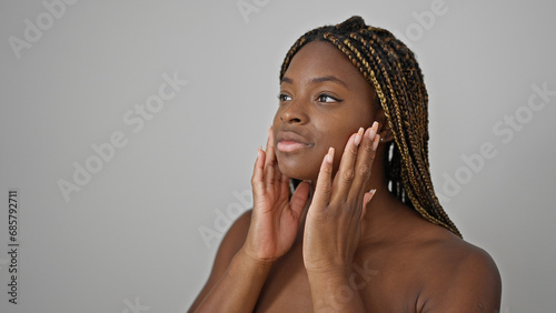 African american woman massaging face over isolated white background