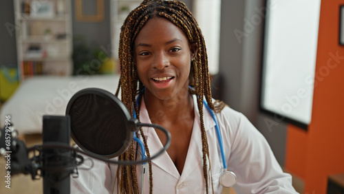 African american woman doctor having interview at radio studio