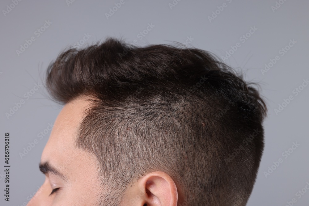 Obraz premium Man with healthy hair on light grey background, closeup
