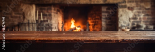 Old Wooden Table With Warm Fireplace In Background