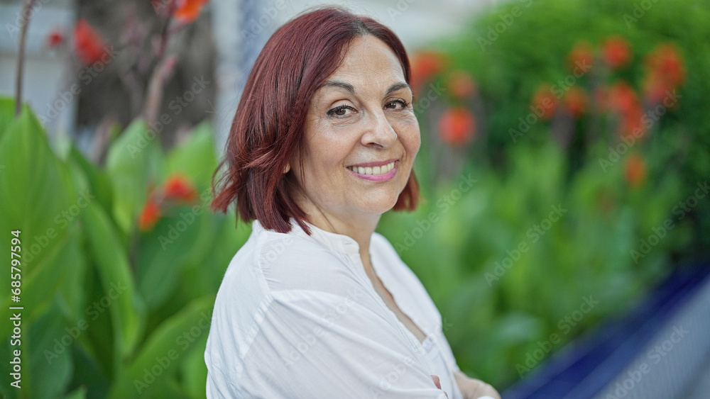 Middle age woman smiling confident standing at park Middle age woman smiling confident standing at park
