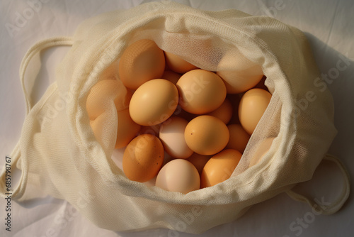 Eggs in a white fabric bag on a light background photo