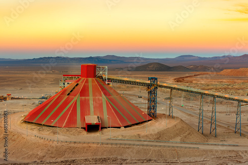Conveyor belt and stockpile under a dome at an open-pit copper mine in Chile. photo