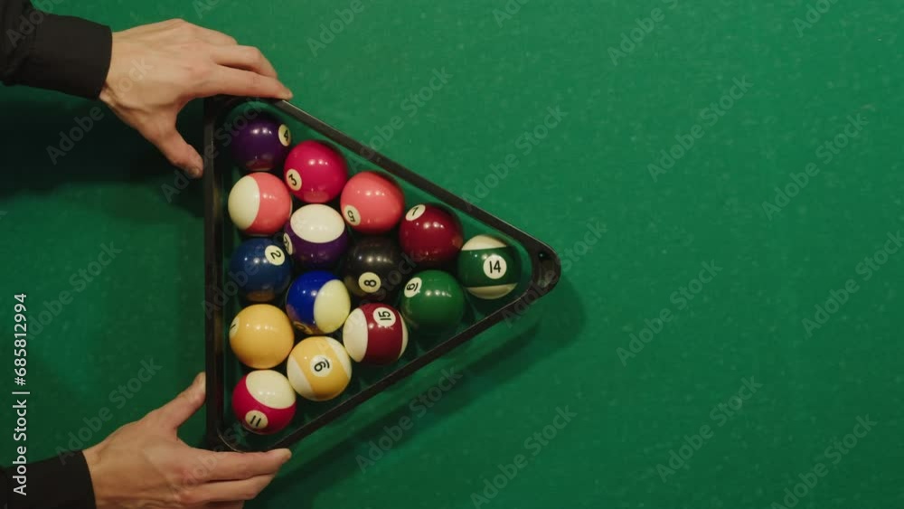 Beginning of game colorful pool balls top view on green billiards table for start to play. American pool, poule. Billiard balls with numbers on a pool table. Billiards team sport.