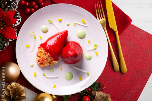 Piquillo peppers stuffed with cod. Traditional Spanish tapa served on a table with Christmas decorations. photo