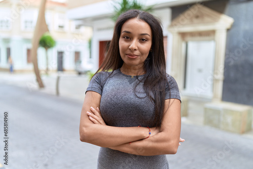 Young arab woman standing with arms crossed gesture at street Free Download Young arab woman standing with arms crossed gesture at street - GFXLoad