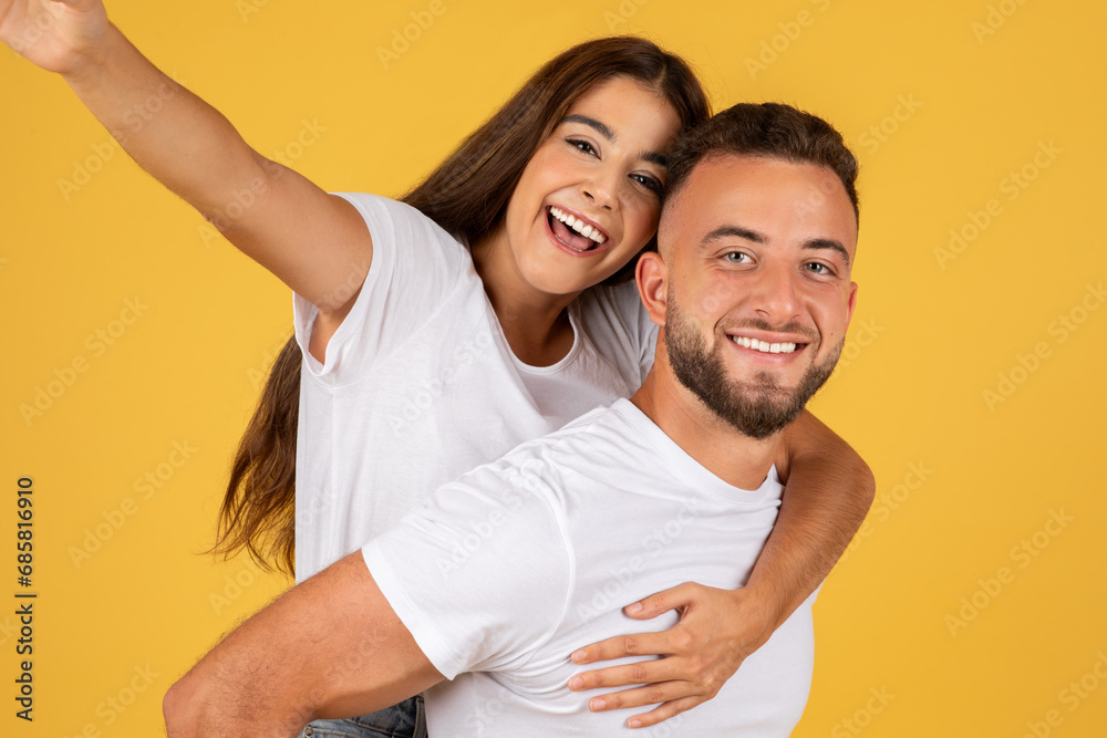Glad millennial european lady in white t-shirts have fun, enjoy date, hugs, make selfie Glad millennial european lady in white t-shirts have fun, enjoy date, hugs, make selfie