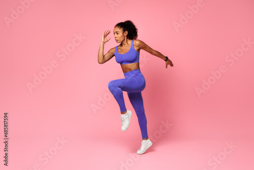 Athletic African Lady Jumping Exercising During Training Over Pink Background