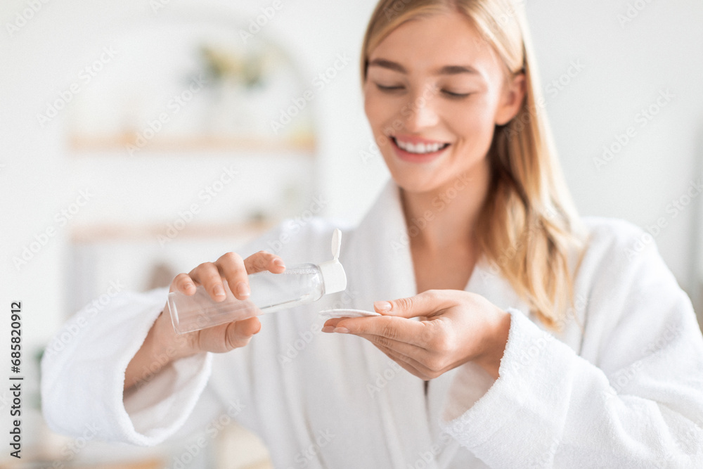 Blonde Lady Using Cotton Pad And Micellar Water In Bathroom Blonde Lady Using Cotton Pad And Micellar Water In Bathroom