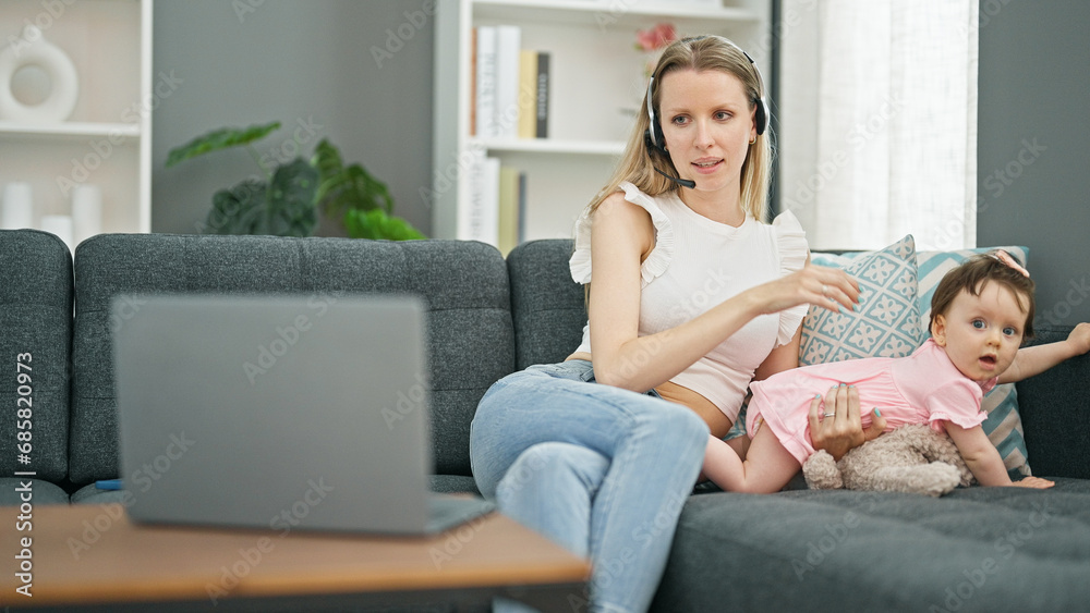 Mother and daughter working while care baby at home