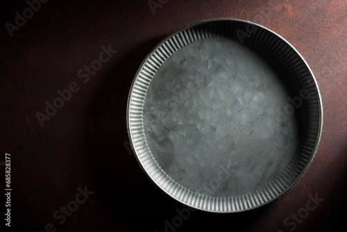 Empty metal dish on a kitchen table photo