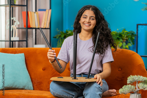 Happy Indian Hindu woman finishing assembling furniture at home. Successful table desk collect repair fixing. Arabian girl after moving into new apartment. Advertisement of a furniture store. Mortgage