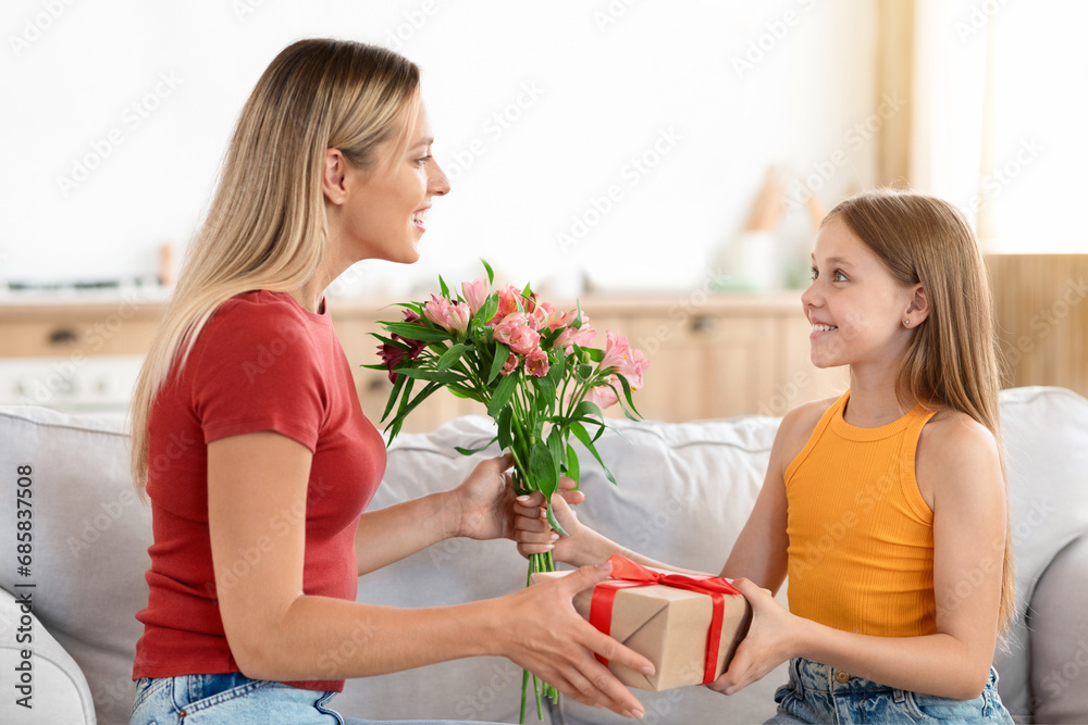 Cute preteen daughter greeting her beautiful mom with birthday Cute preteen daughter greeting her beautiful mom with birthday