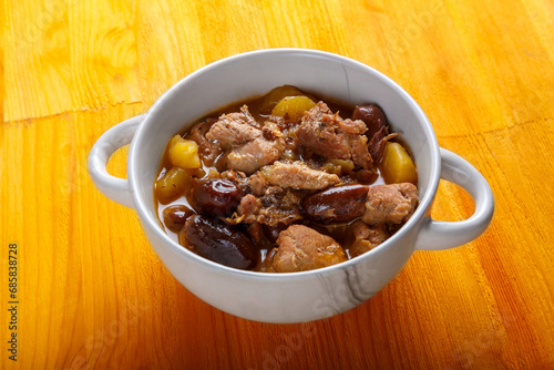 Lamb stewed with potatoes in spices and sauce in a soup bowl on the table