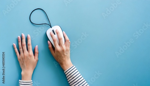 woman using modern wired optical mouse on light blue background top view space for text