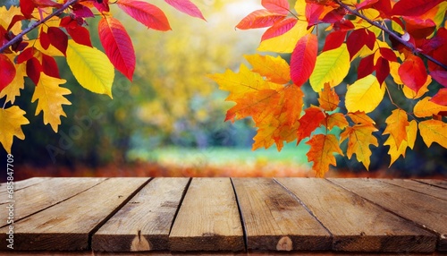 wooden table and blurred autumn background autumn concept with red yellow leaves background