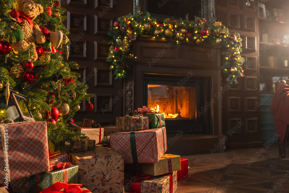 Fototapeta premium Classical Christmas decorated interior living room library with fireplace. Christmas tree with red golden ornament decorations. Modern classic style interior design apartment. Christmas eve at home