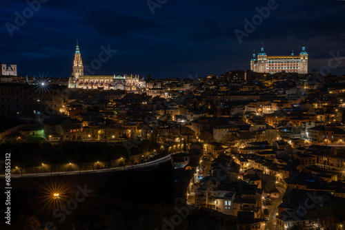 Historic center of Toledo, Spain, at night with the light of street lamps and the cathedral and Alcazar (army museum) illuminated. UNESCO World Heritage Site