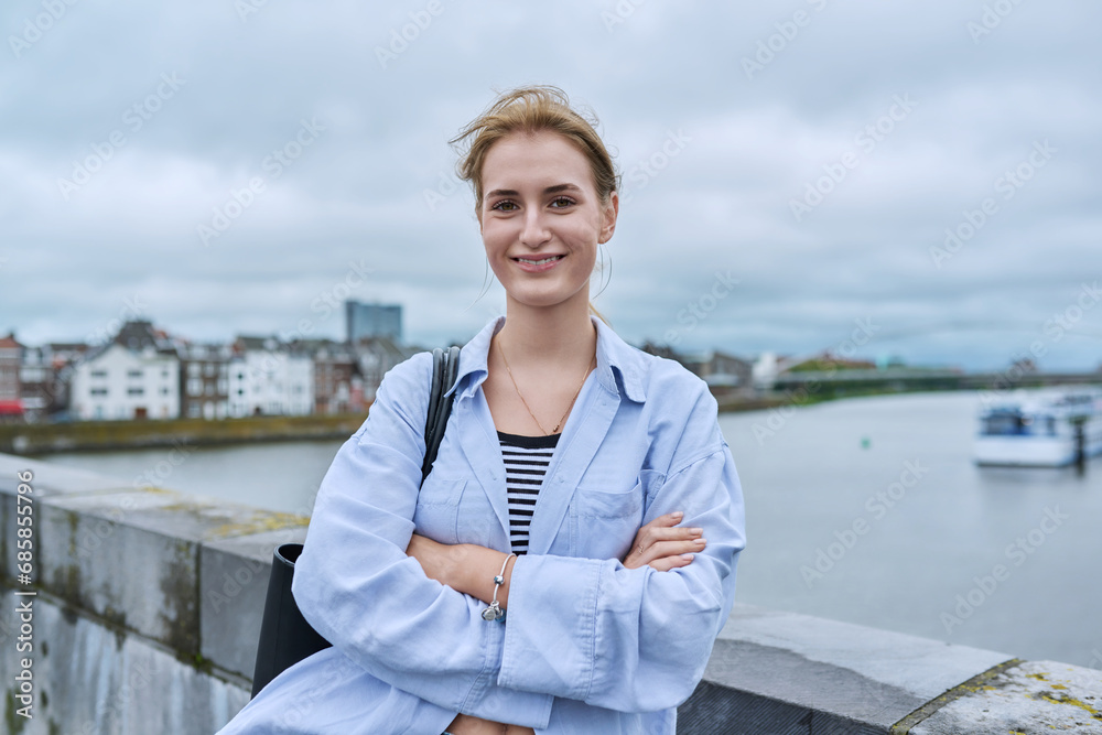 Portrait of smiling young teenage girl looking at camera outdoor