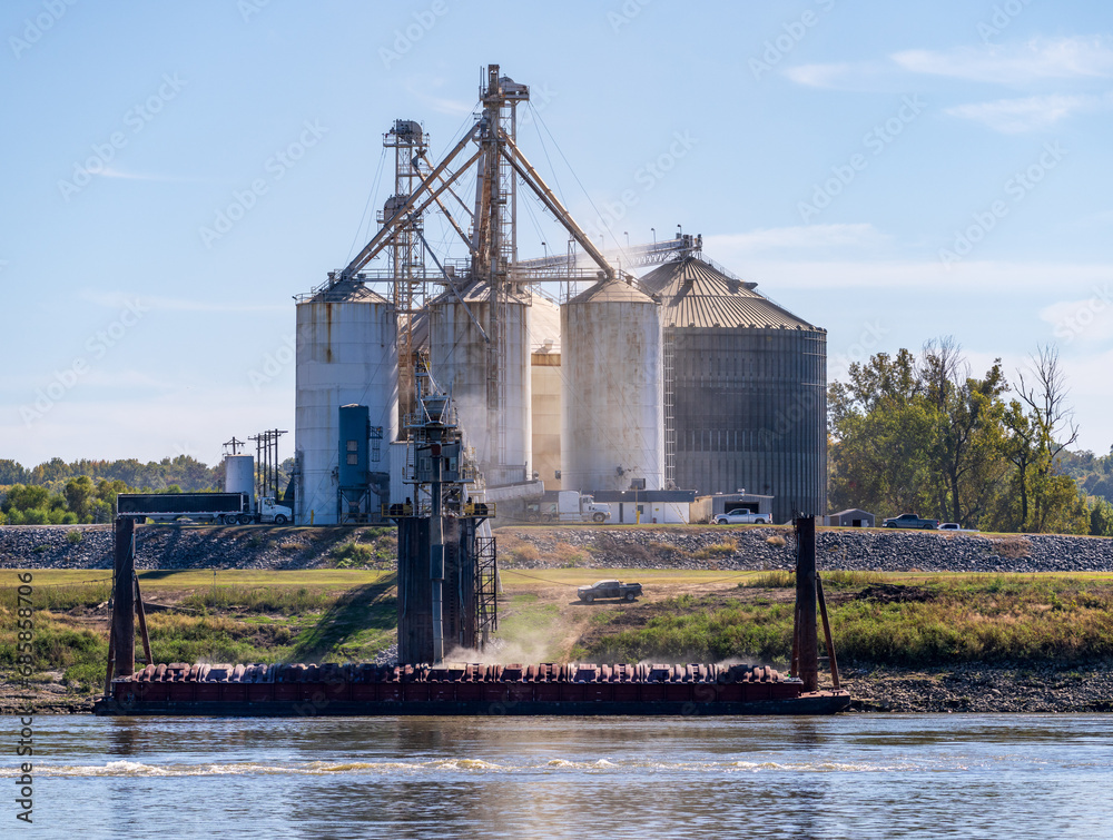 Grain loading dock in farming country in Kentucky with barge being filled with produce