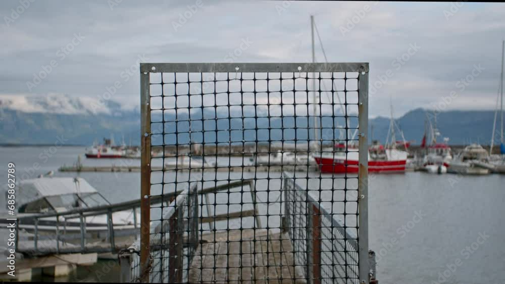 Skutvik Harbor With Grid Fence And Docked Boats Skutvik Harbor With Grid Fence And Docked Boats