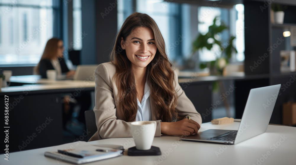 Happy woman working on a laptop in the office Happy woman working on a laptop in the office