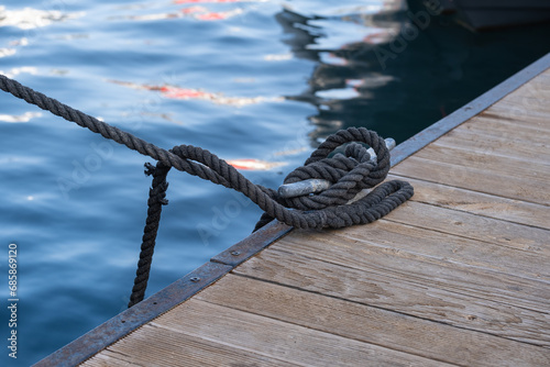 rope and cleat on wooden pier.