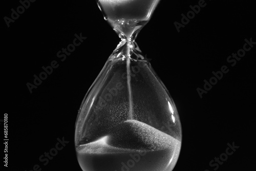 Hourglass. Sands move through hour glass. Close up. Pass of time and waste time concept