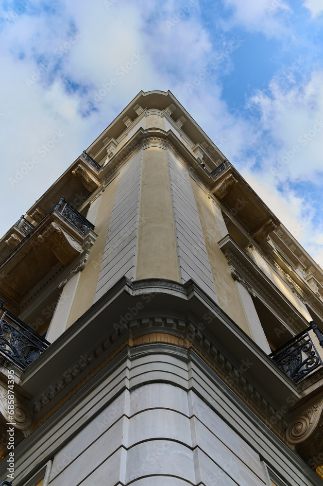 Facade of an old building in Greece taken from the bottom up against the sky