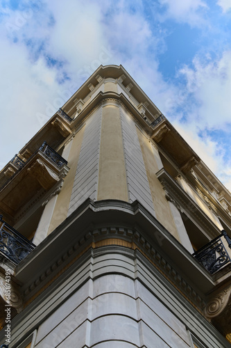 Facade of an old building in Greece taken from the bottom up against the sky