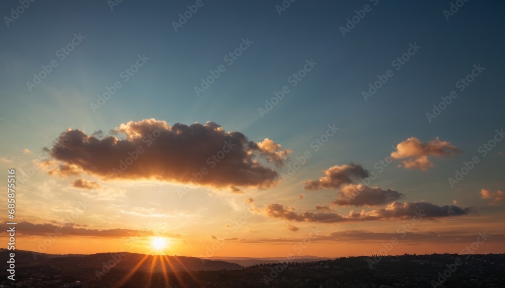  the sun is setting behind a cloud in a blue sky over a hilly area with hills in the foreground and a blue sky with white clouds in the background.