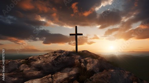 A solitary cross standing on a hilltop against a dramatic sunset.