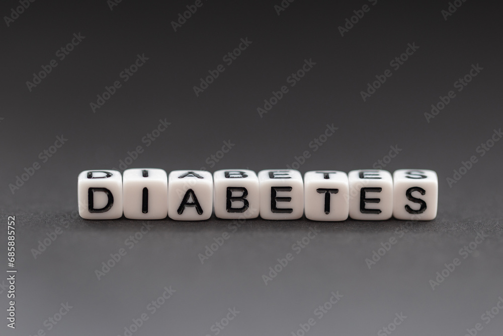 The name diabetes created by white beads on a gray background. The name diabetes created by white beads on a gray background.