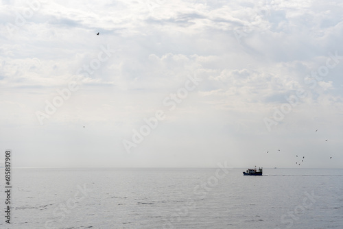 Beautiful Coastal Landscape with Sailing Ship on Horizon