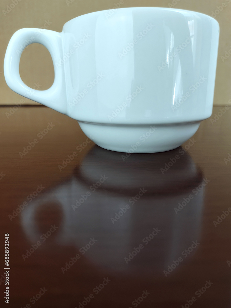 Mug of coffee on the polished wooden table
Mug of coffee on the polished wooden table