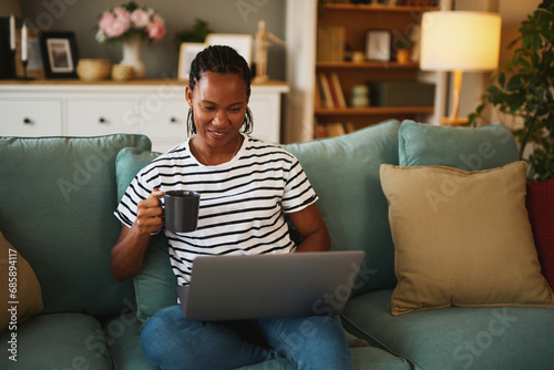 Happy african american woman with laptop at home