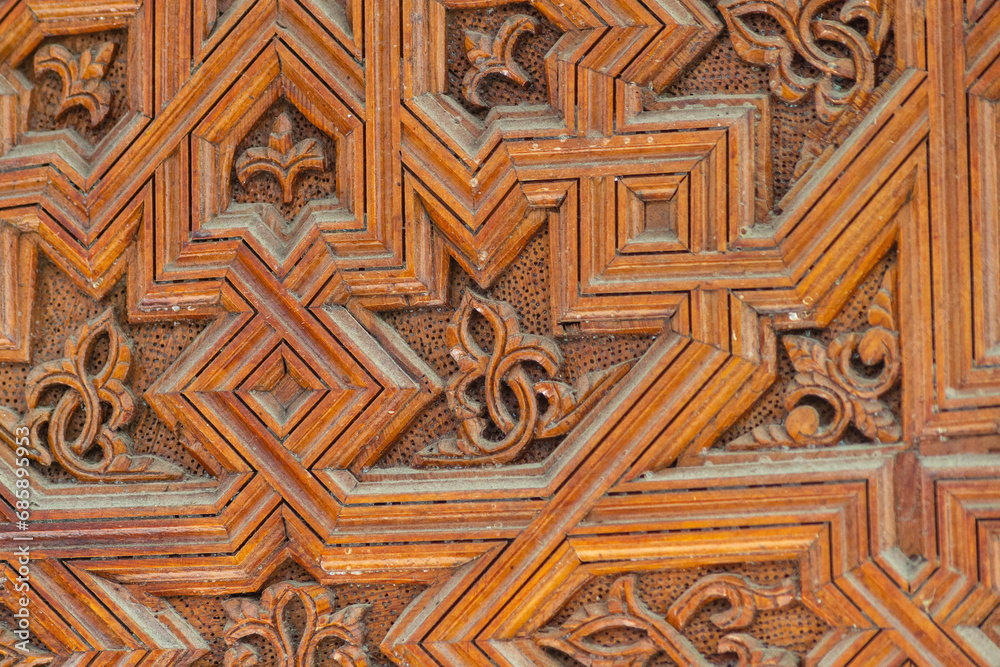 Wood carving with sacred geometric patterns. Manual labor of a woodworking master