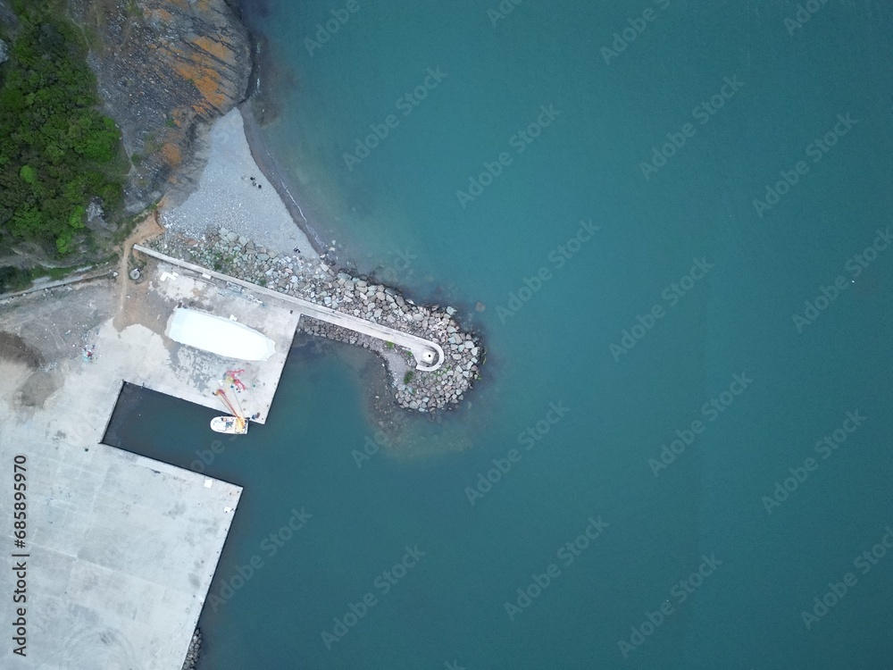 lighthouse in blue water - top view aerial shot.