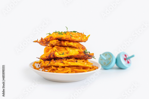 Sweet potato Batata fritters or latkes for Jewish holiday Hanukkah on white background. photo