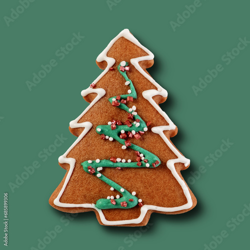 Gingerbread christmas treesisolated on green pastel background photo