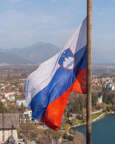 Slovenian flag at beautiful Lake Bled with town in the background photo