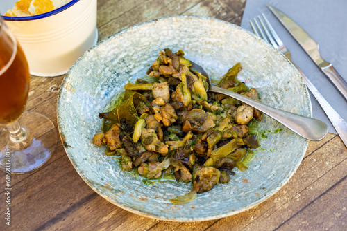 Portion of traditional Aragonese dish, lechecillas de ternasco, served on plate. photo