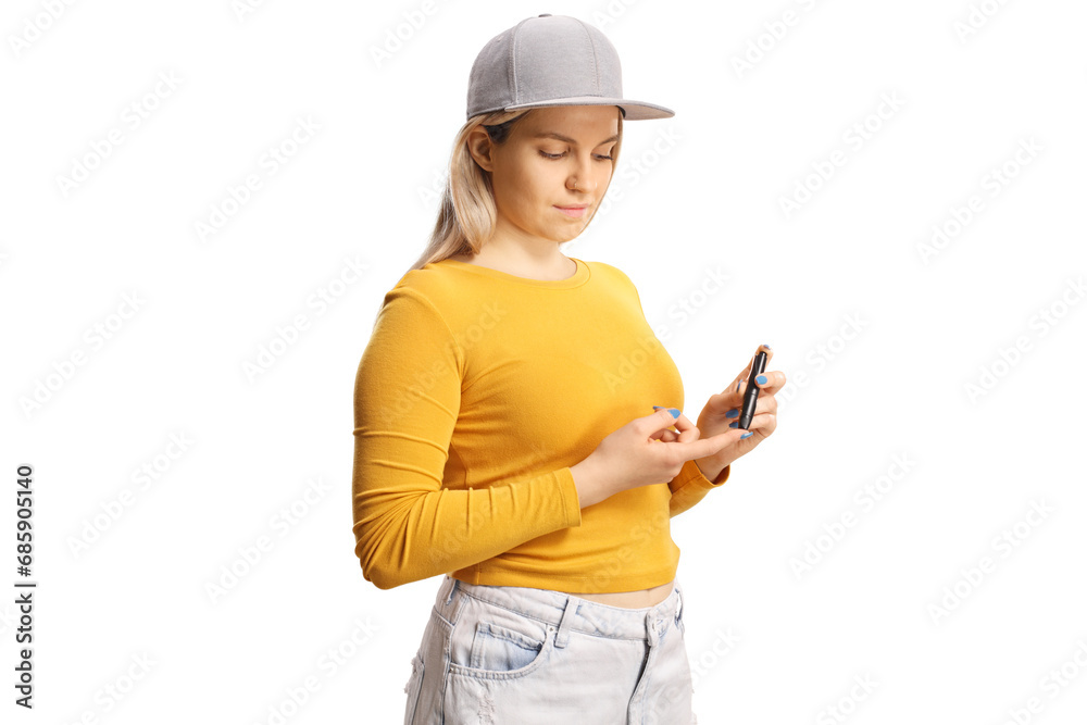 Young female poking finger with an insulin pen
