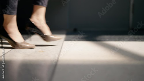 close-up of foot legs business woman with high heel shoes Walking in the Center of Big City with Blurred Pedestrians photo