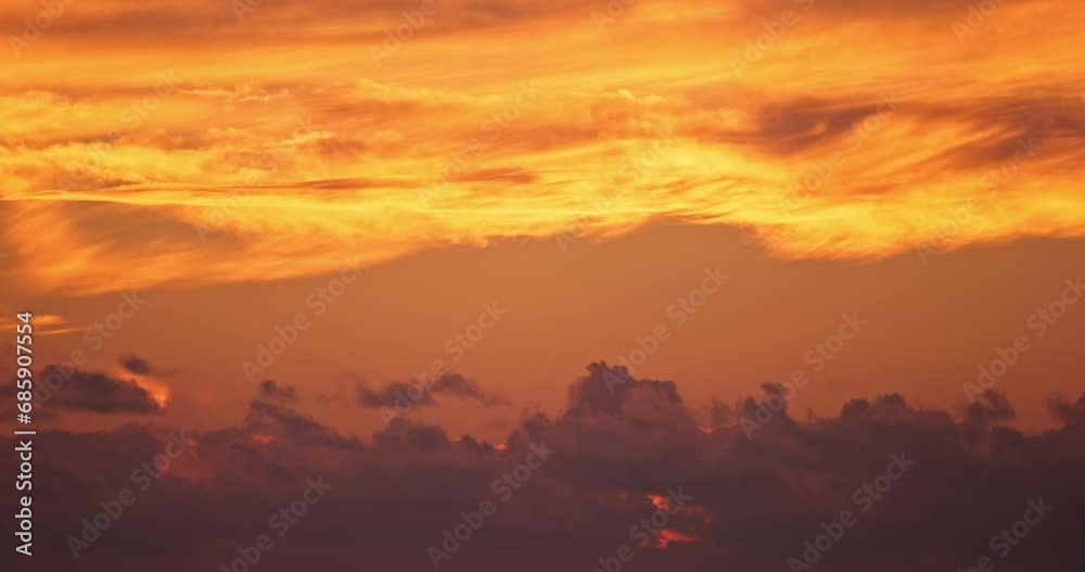 Fiery sunset sky clouds abstract time laps background, global warming or cliamte change video footage timelaps, high quality cinematic natural shot, vivid bright colors sunsets moving.