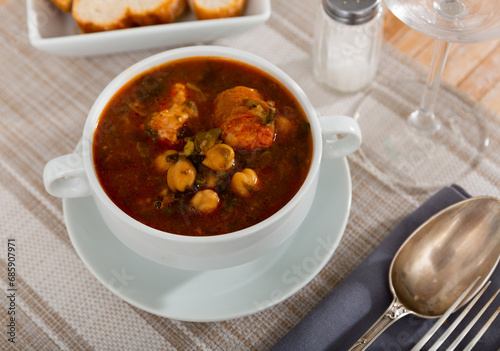 Hearty traditional Spanish soup with beans, chickpeas and meat