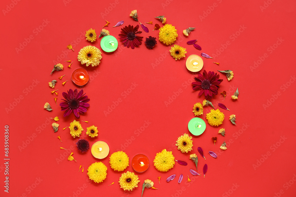 Frame made of burning candles and beautiful flowers on red background. Divaly celebration Frame made of burning candles and beautiful flowers on red background. Divaly celebration