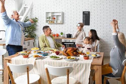 Happy family playing word guessing game at festive table on Thanksgiving Day photo